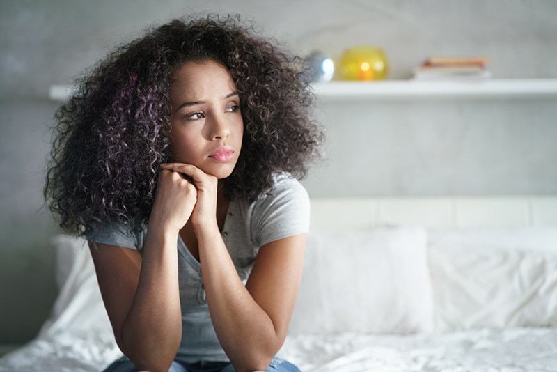 African-American woman looking off to side in contemplation.