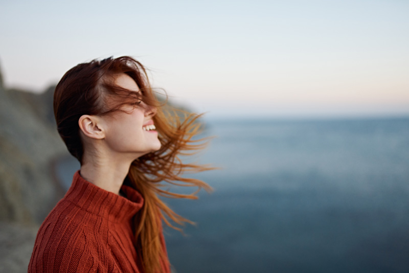 Woman turned to the side looking up with a slight smile